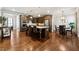 Open kitchen boasts a center island, stainless steel appliances, and a connected dining area with modern lighting at 95 Nesbit Reserve Ct, Alpharetta, GA 30022