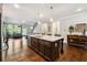 Open kitchen with granite countertops, stainless steel appliances, and hardwood floors at 95 Nesbit Reserve Ct, Alpharetta, GA 30022
