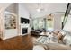 Cozy living room featuring a fireplace, built-in shelving, and hardwood floors at 95 Nesbit Reserve Ct, Alpharetta, GA 30022