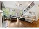 Bright living room featuring hardwood floors, a ceiling fan, and staircase at 95 Nesbit Reserve Ct, Alpharetta, GA 30022