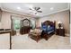 This is a spacious main bedroom with ceiling fan, accent pillows, and carpet floors at 95 Nesbit Reserve Ct, Alpharetta, GA 30022