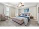 Tranquil main bedroom with tray ceilings, soft natural light, and a comfortable seating area with a plush chair at 95 Nesbit Reserve Ct, Alpharetta, GA 30022