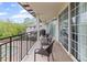 Relaxing covered balcony featuring chairs and a view of mature trees and a fountain at 3101 Howell Mill Nw Rd # 301, Atlanta, GA 30327