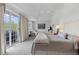 Bright bedroom with two beds, access to a balcony, seating area, and neutral decor at 3101 Howell Mill Nw Rd # 301, Atlanta, GA 30327