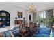 Formal dining room with a chandelier, a large area rug and access to the balcony at 3101 Howell Mill Nw Rd # 301, Atlanta, GA 30327