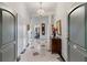 Elegant condo foyer with tiled floor, a chandelier, and classic architectural details at 3101 Howell Mill Nw Rd # 301, Atlanta, GA 30327