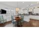 Eat-in kitchen features hardwood floors, white cabinets, a round table and a large window at 3101 Howell Mill Nw Rd # 301, Atlanta, GA 30327