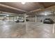 Well-lit parking garage with parking spaces, concrete construction, and visible vehicles at 3101 Howell Mill Nw Rd # 301, Atlanta, GA 30327