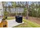 Spacious backyard featuring a patio, grill, and lush greenery, perfect for outdoor entertaining and relaxation at 3736 Chevington Se Ct, Atlanta, GA 30354