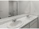 Modern bathroom featuring double sinks with marble countertops and large mirrors for a bright, open feel at 3736 Chevington Se Ct, Atlanta, GA 30354