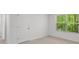 Room features large windows and neutral colored walls and carpeting at 3736 Chevington Se Ct, Atlanta, GA 30354