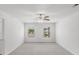 Bright bedroom with ceiling fan, two windows, and neutral carpeting at 3736 Chevington Se Ct, Atlanta, GA 30354