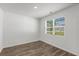 Well-lit bedroom with hard surface floors, a large window, and neutral paint at 3736 Chevington Se Ct, Atlanta, GA 30354
