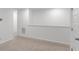 Bedroom with neutral carpeting and paint, adjacent to an open hallway and a doorway at 3736 Chevington Se Ct, Atlanta, GA 30354