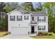 Charming two-story home featuring a white exterior, black shutters, and an attached two-car garage at 3736 Chevington Se Ct, Atlanta, GA 30354