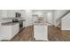 Modern kitchen features an island with granite countertop and stainless steel appliances at 3736 Chevington Se Ct, Atlanta, GA 30354