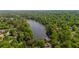 Stunning aerial view of lake surrounded by lush trees and upscale homes at 5145 Davantry Dr, Dunwoody, GA 30338