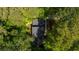 Aerial view of a home surrounded by lush green trees in a wooded area at 5145 Davantry Dr, Dunwoody, GA 30338