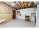 Unfinished basement with exposed ceiling beams and painted concrete floor at 5145 Davantry Dr, Dunwoody, GA 30338