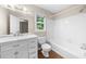 Bright bathroom with tiled floors, vanity, and a combined tub and shower at 5145 Davantry Dr, Dunwoody, GA 30338