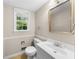 Well-lit bathroom featuring a window, neutral walls, and a vanity with sink at 5145 Davantry Dr, Dunwoody, GA 30338
