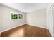 Neutral bedroom featuring hardwood floors, closet, and natural light from the window at 5145 Davantry Dr, Dunwoody, GA 30338