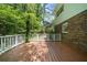 Wide wood deck offers scenic view of wooded backyard and brick house exterior at 5145 Davantry Dr, Dunwoody, GA 30338