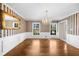Elegant dining room with hardwood floors, wainscoting, and a chandelier at 5145 Davantry Dr, Dunwoody, GA 30338