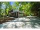 Long driveway leading to a well-maintained home with an attached garage and a spacious parking area at 5145 Davantry Dr, Dunwoody, GA 30338
