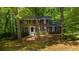Charming two-story brick home featuring classic shutters and surrounded by lush trees and landscaping at 5145 Davantry Dr, Dunwoody, GA 30338