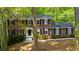 Traditional brick home with black shutters, bright white trim, and a well-manicured front lawn at 5145 Davantry Dr, Dunwoody, GA 30338