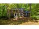 Two-story brick home with black shutters and a front yard surrounded by trees at 5145 Davantry Dr, Dunwoody, GA 30338