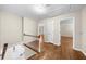 Hallway with hardwood floors, white trim, and access to multiple rooms at 5145 Davantry Dr, Dunwoody, GA 30338
