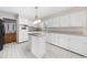 Functional kitchen with white cabinets, an island, and tile flooring at 5145 Davantry Dr, Dunwoody, GA 30338