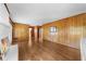 Open living room featuring wood paneled walls and hardwood floors at 5145 Davantry Dr, Dunwoody, GA 30338