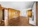 Well-lit living room with wood paneled walls, hardwood floors, and a white fireplace at 5145 Davantry Dr, Dunwoody, GA 30338