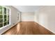 A bright living room with hardwood floors and large windows overlooking a lush green yard at 5145 Davantry Dr, Dunwoody, GA 30338