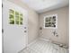Functional mud room with tiled floors, large window, and exterior door at 5145 Davantry Dr, Dunwoody, GA 30338