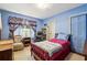 Comfortable bedroom with blue walls, patterned curtains, and classic furnishings at 671 Valley Green Ne Dr, Atlanta, GA 30342