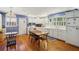 Charming kitchen with white cabinetry, hardwood floors, and a dining table at 671 Valley Green Ne Dr, Atlanta, GA 30342