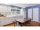 Bright kitchen featuring white cabinets, an eat-in table, and lots of natural light at 671 Valley Green Ne Dr, Atlanta, GA 30342