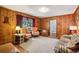 Vintage-style living room featuring wood paneling and traditional furniture at 671 Valley Green Ne Dr, Atlanta, GA 30342