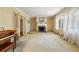 Elegant living room featuring a fireplace, grand piano, and large windows with sheer curtains at 671 Valley Green Ne Dr, Atlanta, GA 30342