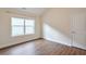 Well-lit bedroom with wood flooring, trim, and large window at 807 Bridget Sw Walk, Powder Springs, GA 30127