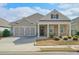 Charming single-Gathering home featuring a two-car garage, covered porch with stately columns and manicured landscaping at 807 Bridget Sw Walk, Powder Springs, GA 30127