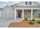Inviting front entrance with brick accents, columns, and well-maintained landscaping at 807 Bridget Sw Walk, Powder Springs, GA 30127