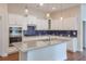 Modern kitchen with white cabinets, granite countertops, stainless steel appliances, and a center island at 807 Bridget Sw Walk, Powder Springs, GA 30127