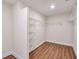 Spacious walk-in closet with wooden floors and custom shelving for optimal storage and organization at 807 Bridget Sw Walk, Powder Springs, GA 30127