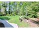 Lush backyard offers a tranquil, garden-like setting with mature trees and varied plantings at 1590 Arden Sw Dr, Marietta, GA 30008