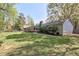 Spacious backyard with beautiful green grass, mature landscaping and wooded surroundings at 1590 Arden Sw Dr, Marietta, GA 30008